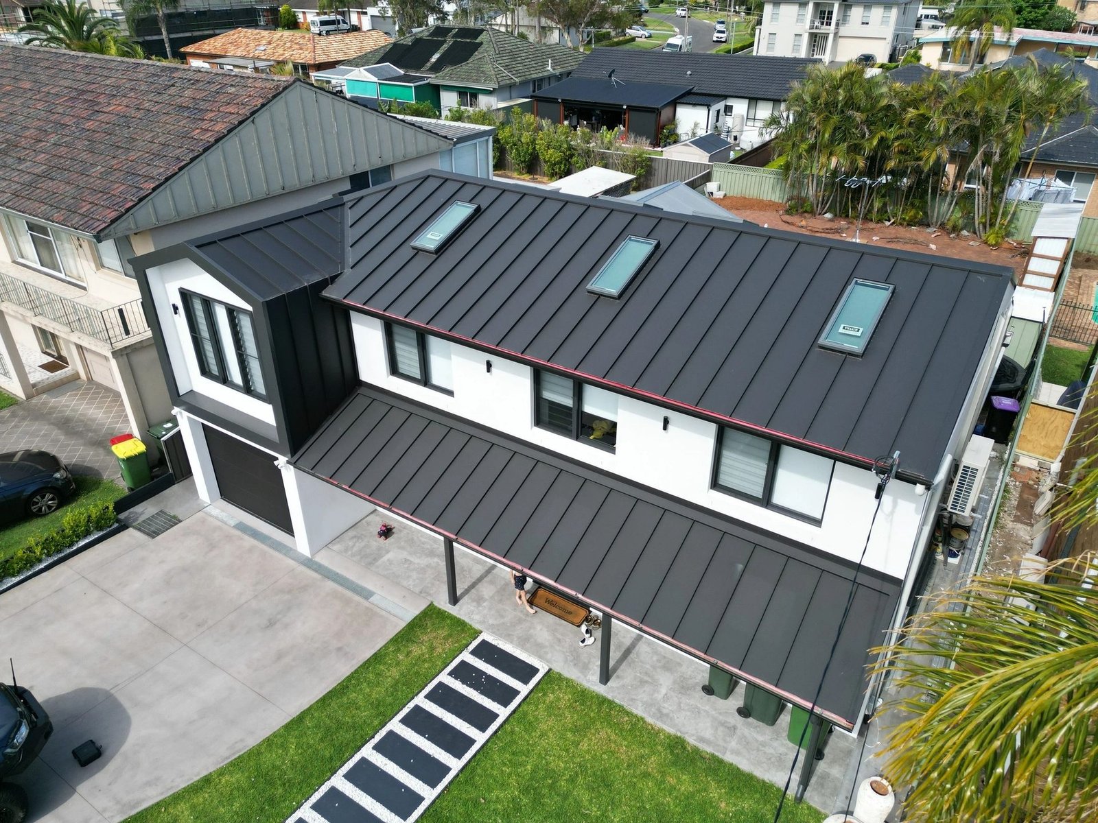 Aerial view of a standing seam metal roof with skylights installed by Reborn Metal Roofing