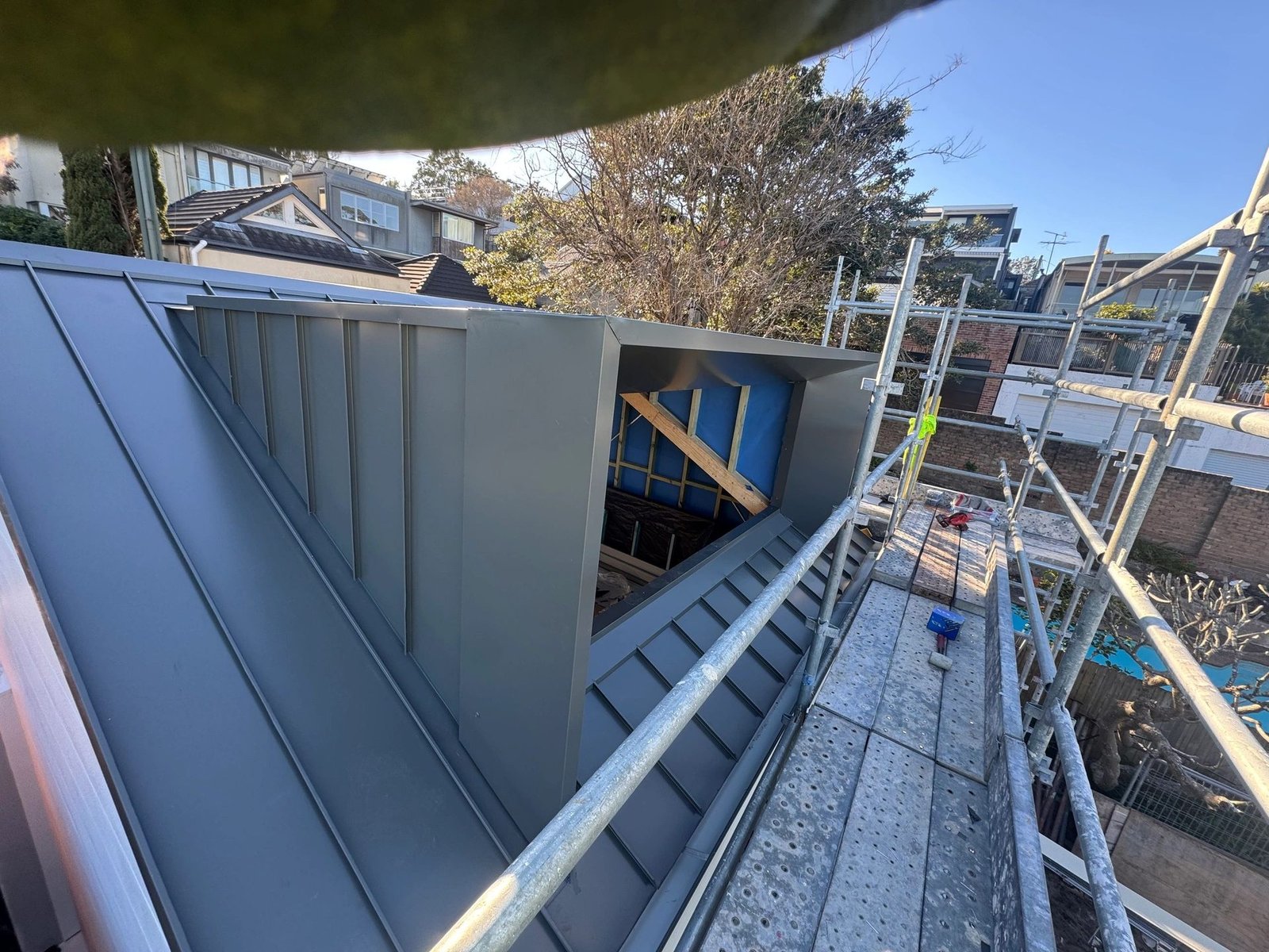 Metal roof and box gutter detail with scaffolding