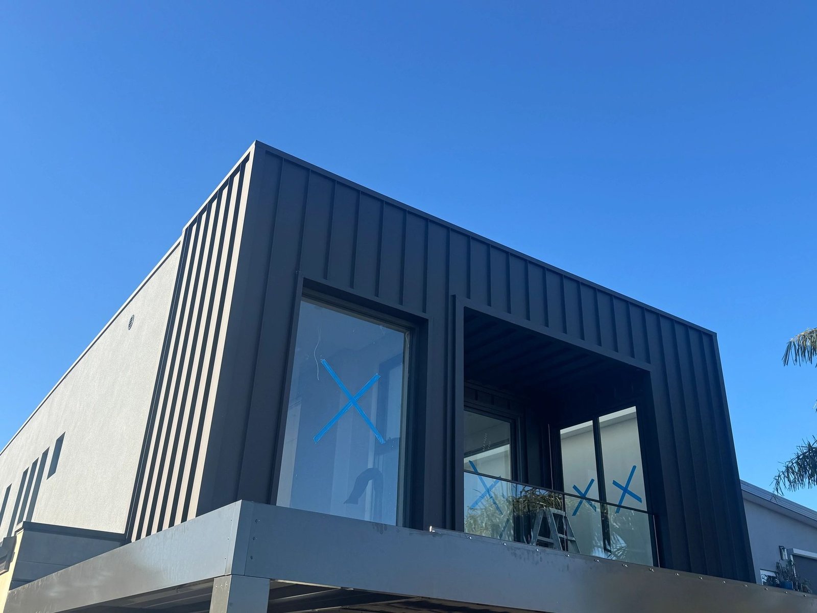 Modern home with dark Colorbond standing seam cladding