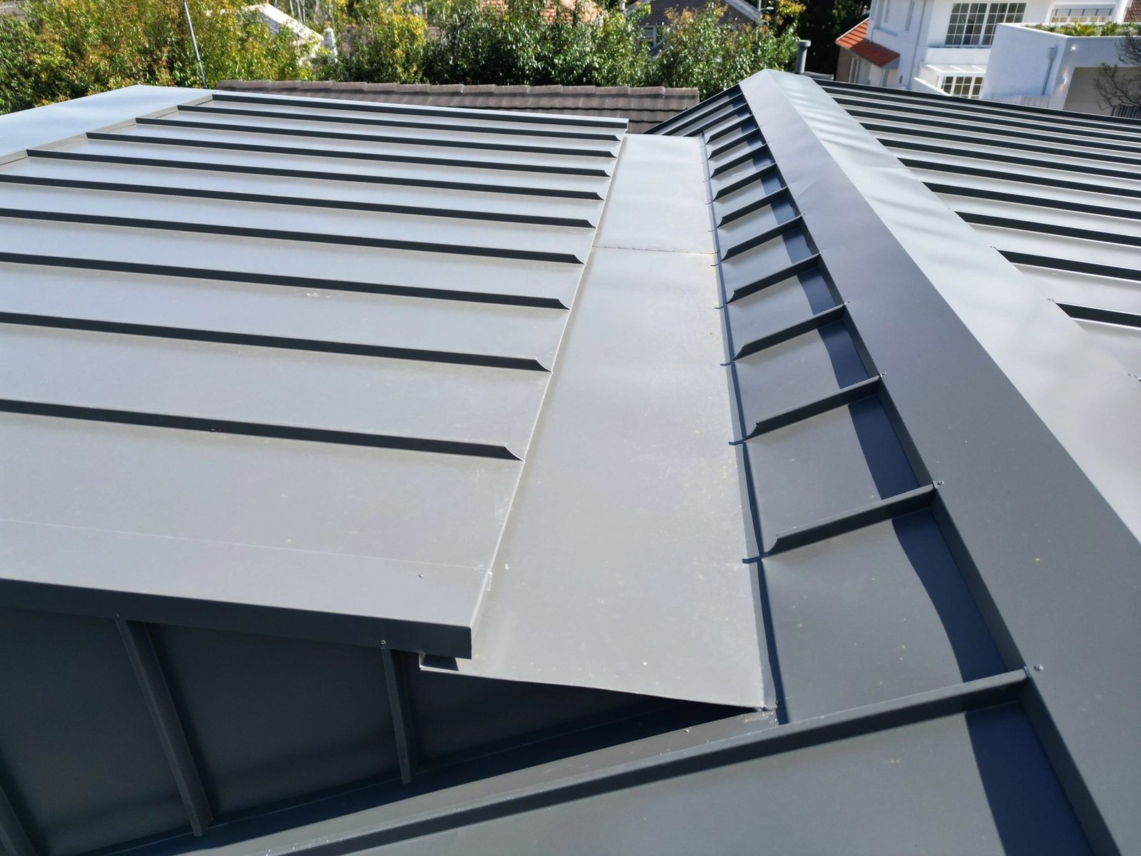 Close-up of standing seam roof sheets and ridge capping